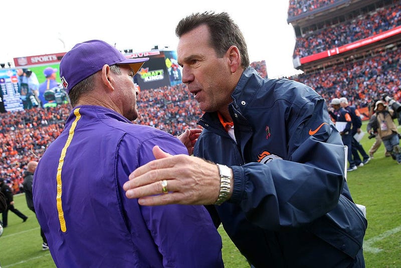Head coach Mike Zimmer of the Minnesota Vikings and head coach Gary Kubiak of the Denver Broncos meet at midfield following their game at Sports Authority Field at Mile High on October 4, 2015 in Denver, Colorado.