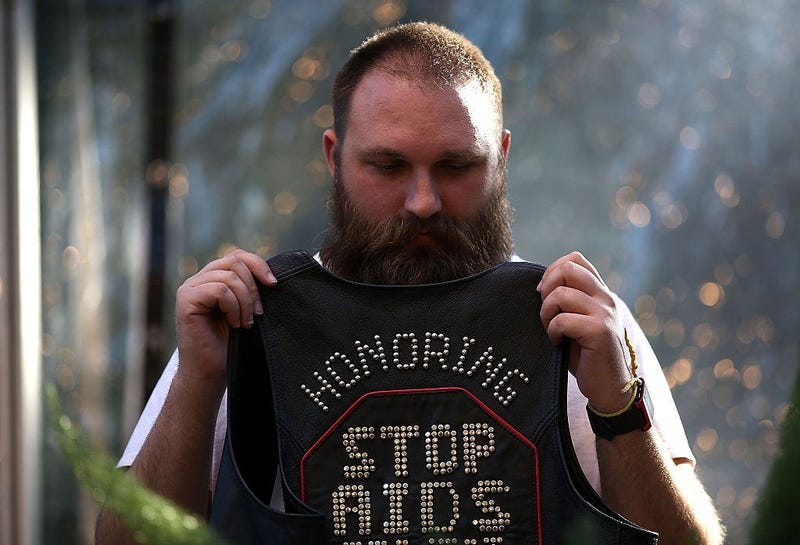 Alexxi Othenin-Girard holds a leather vest during a World AIDS Day commemoration event at the National AIDS Memorial Grove on December 1, 2015 in San Francisco.