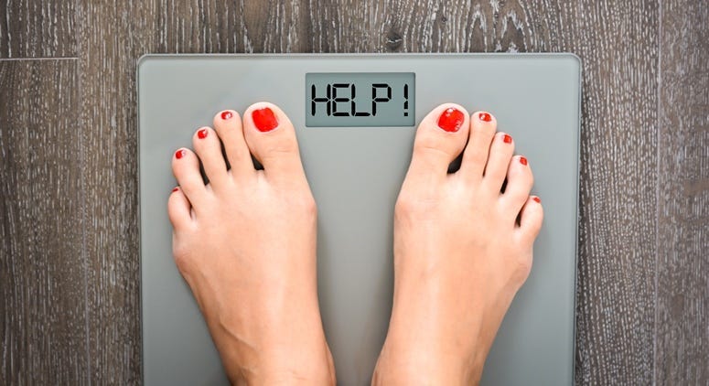 Lose weight concept with person on a scale measuring kilograms