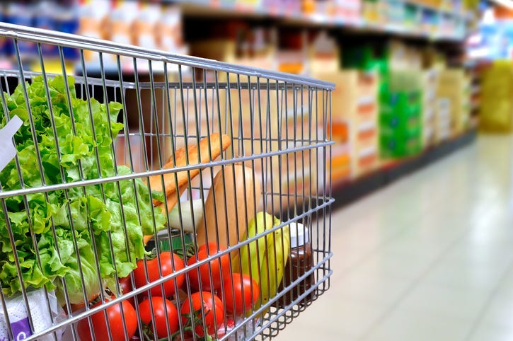 A grocery cart full of food.
