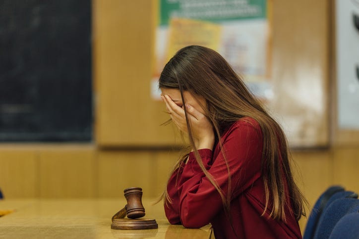 A judge in a courtroom striking the gavel