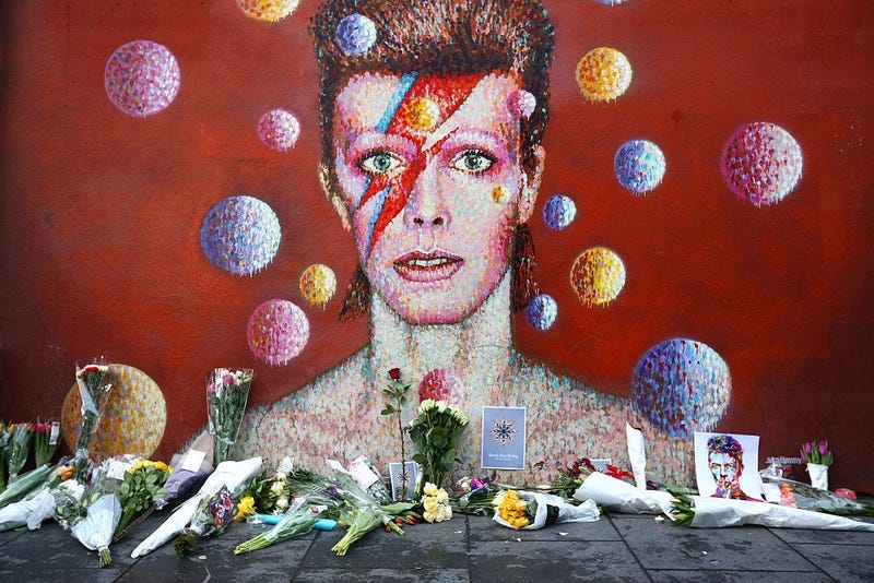 Flowers are laid beneath a mural of David Bowie in Brixton on January 11, 2016 in London, England.
