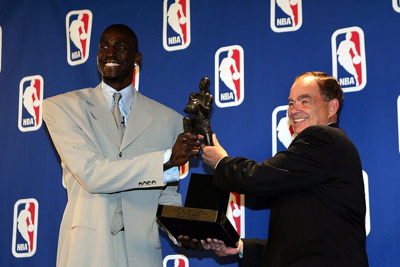 Kevin Garnett #21 of the Minnesota Timberwolves receives the NBA MVP award from Glen Taylor,owner of the Timberwolves on May 3, 2004 at the Target Center in Minneapolis, Minnesota.