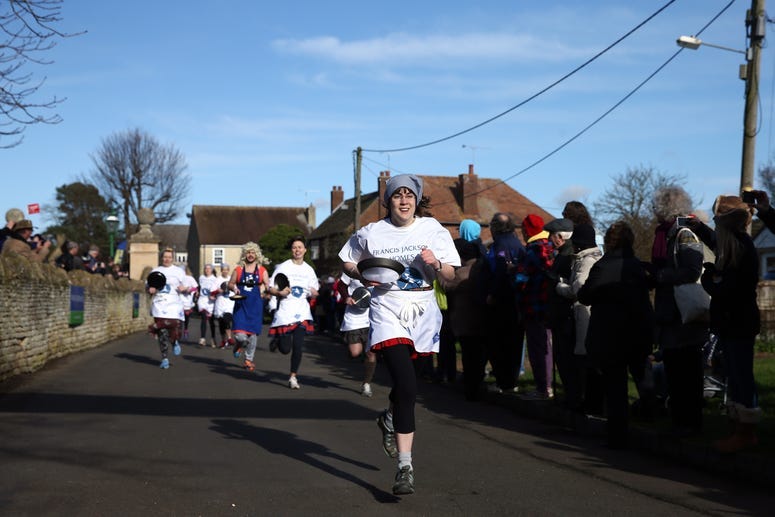 Competitors take part in the annual Shrove Tuesday trans-Atlantic pancake race on February 9, 2016 in Olney, England. On Shrove Tuesday every year the ladies of Olney, Buckinghamshire compete in a Pancake Race, a tradition wh