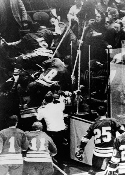 Members of the St. Louis Blues professional hockey team charge into the stands at the end of the second period to fight Philadelphia Flyers fans who threw trash at the Blues' coach, Al Arbour, Philadelphia, January 6, 1972.