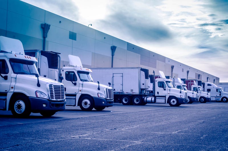 Trucks loading unloading at warehouse 