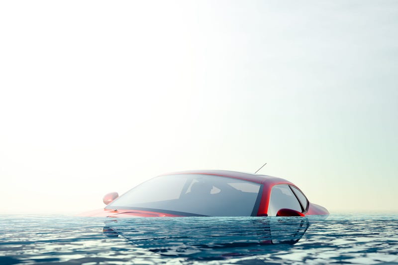 Red Car floating in flood water