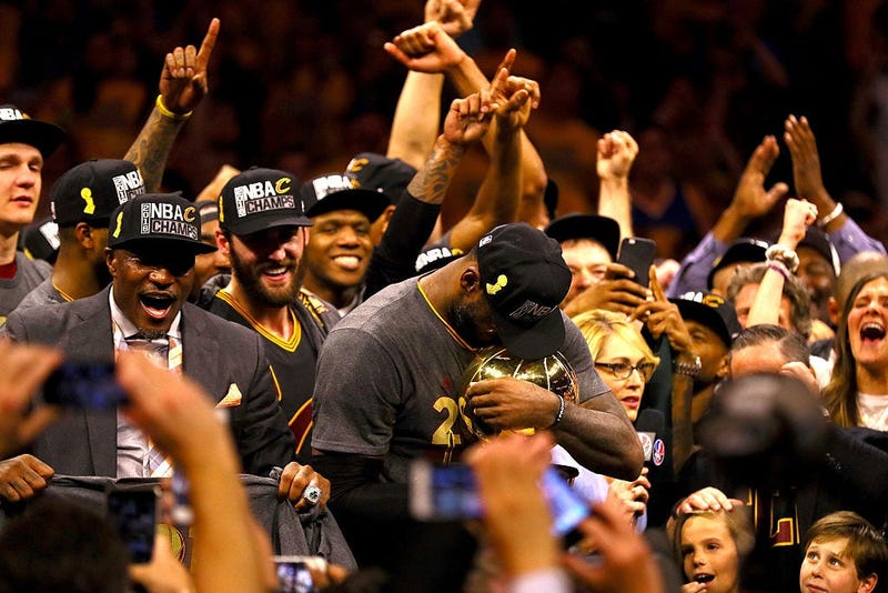 OAKLAND, CA - JUNE 19: LeBron James #23 of the Cleveland Cavaliers holds the Larry O'Brien Championship Trophy after defeating the Golden State Warriors 93-89 in Game 7 of the 2016 NBA Finals at ORACLE Arena on June 19, 2016 in Oakland, California. NOTE T