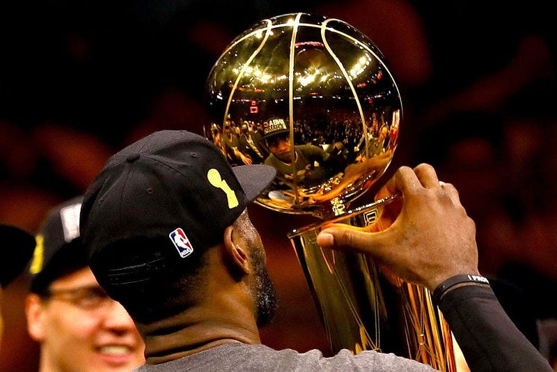 OAKLAND, CA - JUNE 19: LeBron James #23 of the Cleveland Cavaliers holds the Larry O'Brien Championship Trophy after defeating the Golden State Warriors 93-89 in Game 7 of the 2016 NBA Finals at ORACLE Arena on June 19, 2016 in Oakland, California. NOTE T