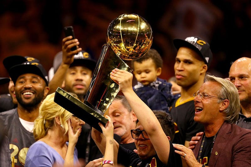 OAKLAND, CA - JUNE 19: Nick Gilbert, son of Cleveland Cavaliers owner Dan Gilbert, holds the Larry O'Brien Championship Trophy after the Cavaliers defeated the Golden State Warriors 93-89 in Game 7 of the 2016 NBA Finals at ORACLE Arena on June 19, 2016 i