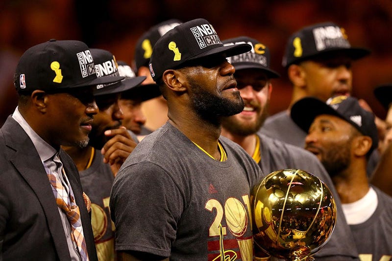 OAKLAND, CA - JUNE 19: LeBron James #23 of the Cleveland Cavaliers celebrates with the Larry O'Brien Championship Trophy after defeating the Golden State Warriors 93-89 in Game 7 of the 2016 NBA Finals at ORACLE Arena on June 19, 2016 in Oakland, Californ