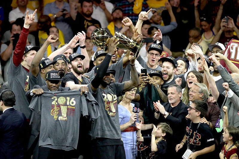 OAKLAND, CA - JUNE 19: LeBron James #23 of the Cleveland Cavaliers celebrates with the Larry O'Brien Championship Trophy after defeating the Golden State Warriors 93-89 in Game 7 of the 2016 NBA Finals at ORACLE Arena on June 19, 2016 in Oakland, Californ