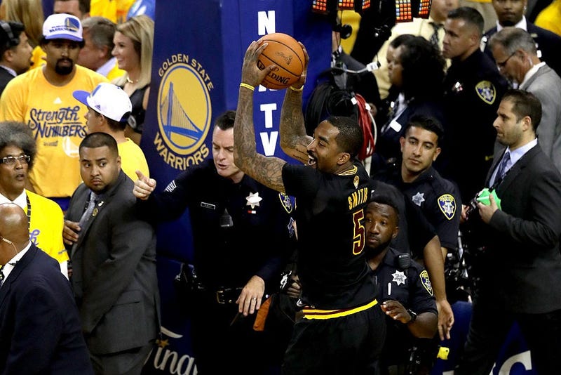 OAKLAND, CA - JUNE 19: J.R. Smith #5 of the Cleveland Cavaliers grabs the game ball at the end of Game 7 after defeating the Golden State Warriors in the 2016 NBA Finals at ORACLE Arena on June 19, 2016 in Oakland, California. NOTE TO USER: User expressly