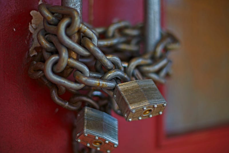 chain and locks on doors of closed business 