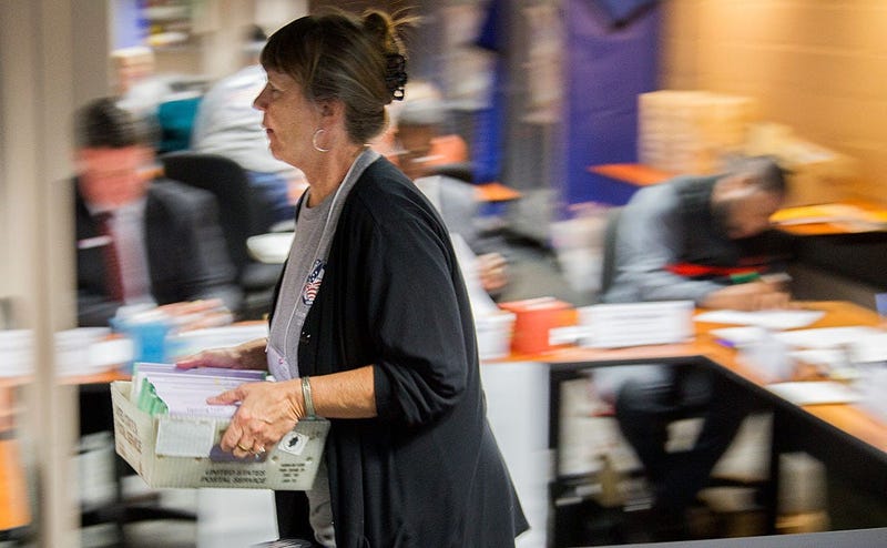 Johanna Stiles carries vote-by-mail ballots after the Leon County, Florida Canvassing Board accepted them on November 8, 2016 in Tallahassee, Florida.
