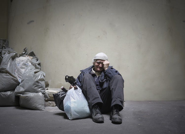 Homelessman is sitting on the ground and crying