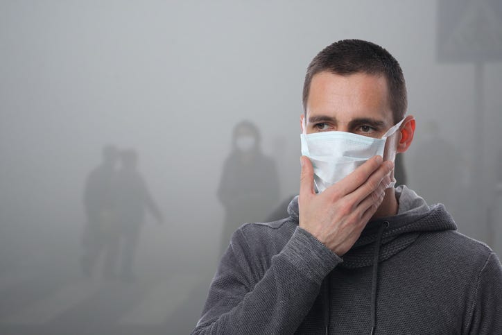 Portrait of man wearing facial hygienic mask outdoors. Ecology, air pollution, Environmental awareness and virus protection concept