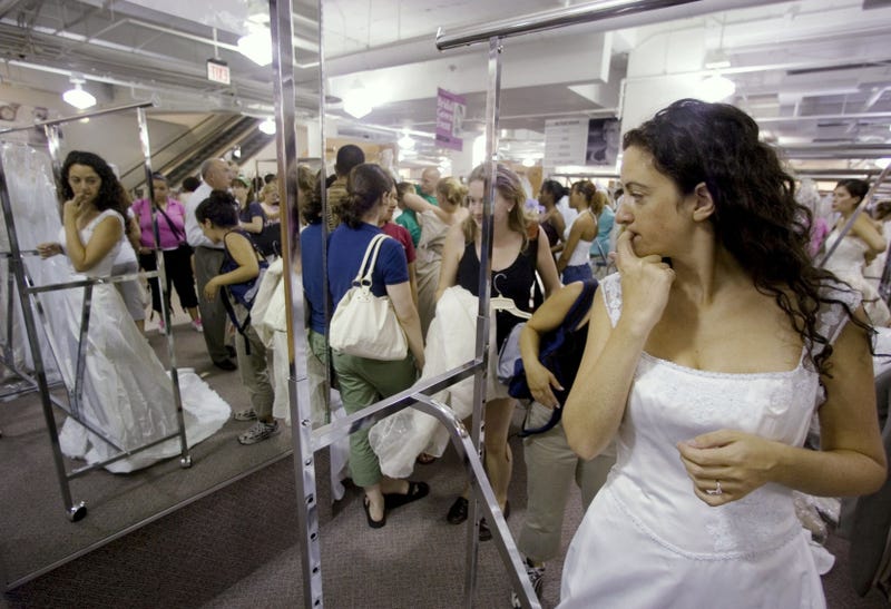 Bride-to-be Jennie Rothenberg tries on a wedding gown during Filene's Basement's annual sale, Aug. 4, 2006 in Washington, D.C.