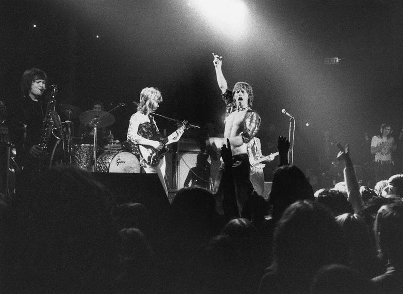 The Rolling Stones perform at the Roundhouse, London, 14th March 1971. The band features Bobby Keys on saxophone, left, and Mick Taylor on guitar, centre. 