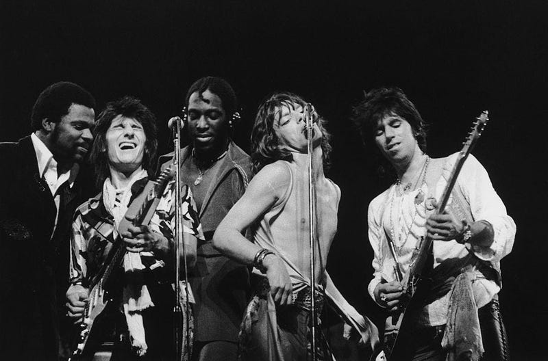 The Rolling Stones headline the Knebworth Festival, 21st August 1976. Left to right: Keyboard player Billy Preston, Giuitarist Ron Wood, percussionist Ollie Brown, singer Mick Jagger and guitarist Keith Richards.