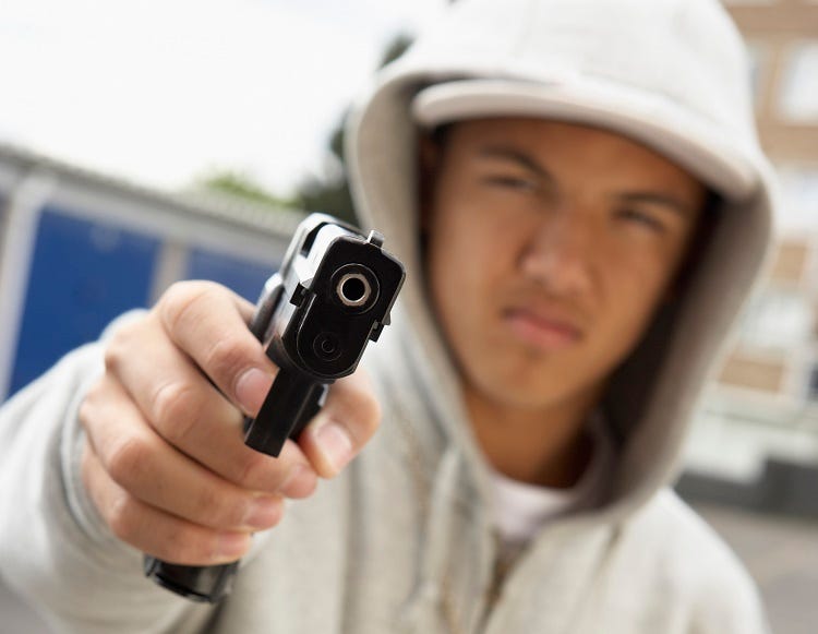 Teenage boy with gun