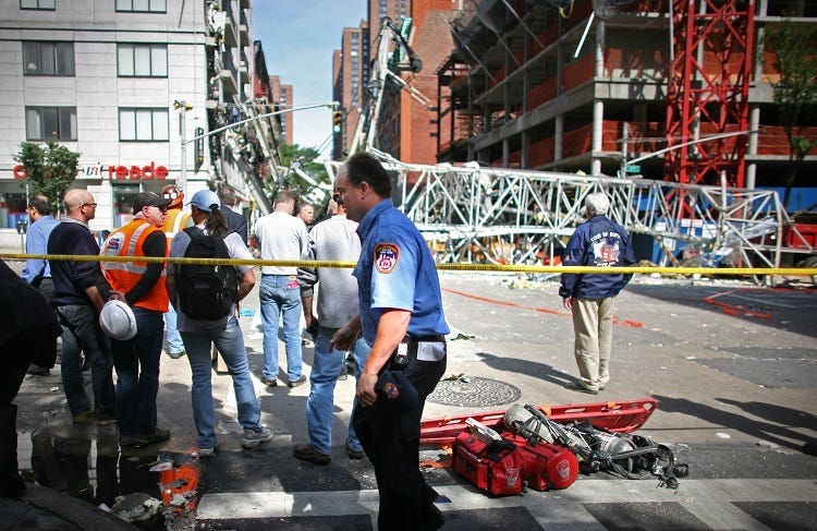 onstruction workers observe the scene of a crane collapse on Manhattan's Upper East Side at 91st Street and 1st Avenue May 30, 2008 in New York. The crane collapsed on top of an apartment building crashing into a penthouse apartment and falling to the gro