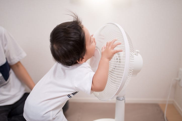 baby and a fan