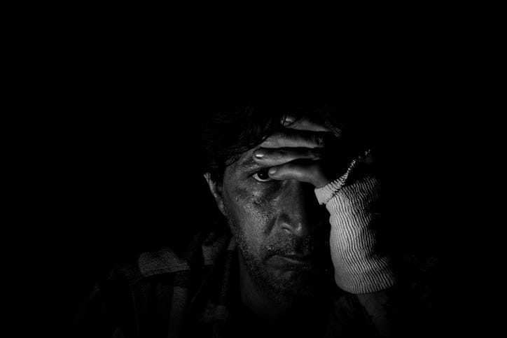 Man sitting alone in dark room