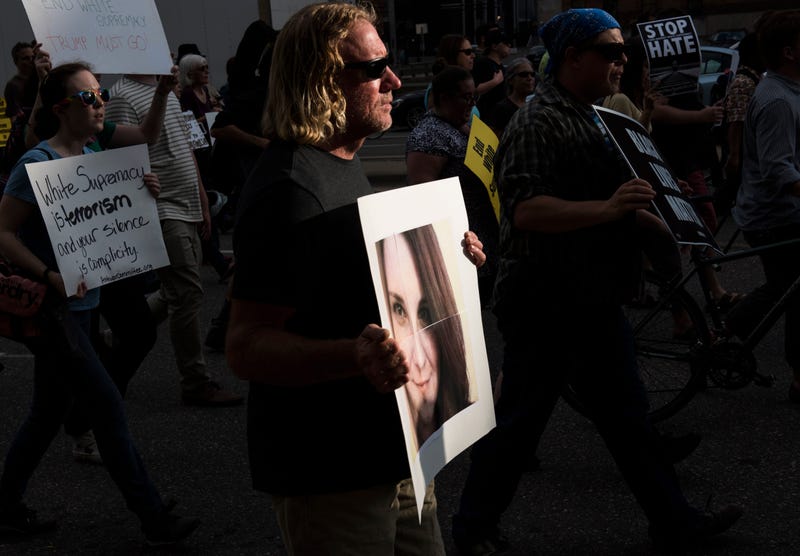 A man carries an image of Heather Heyer during a protest against racism