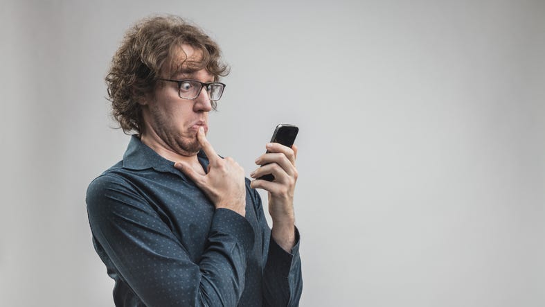 Embarrassed Man on the Phone