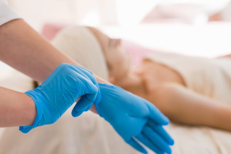 Facialist puts on gloves