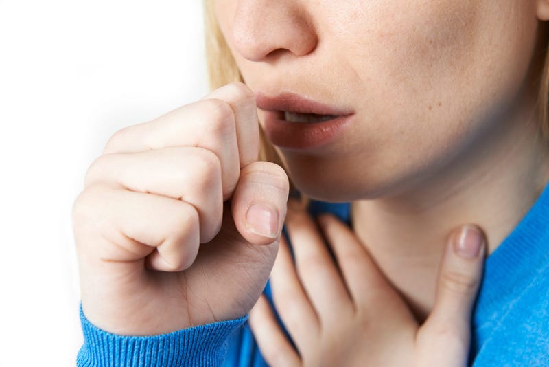 Close-up of woman coughing