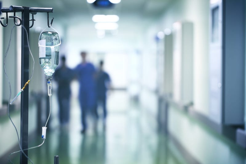 Group of doctors in a hurry down the hospital hallway 