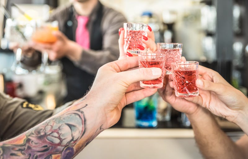 Group of drunk friends toasting cocktails at bar restautant