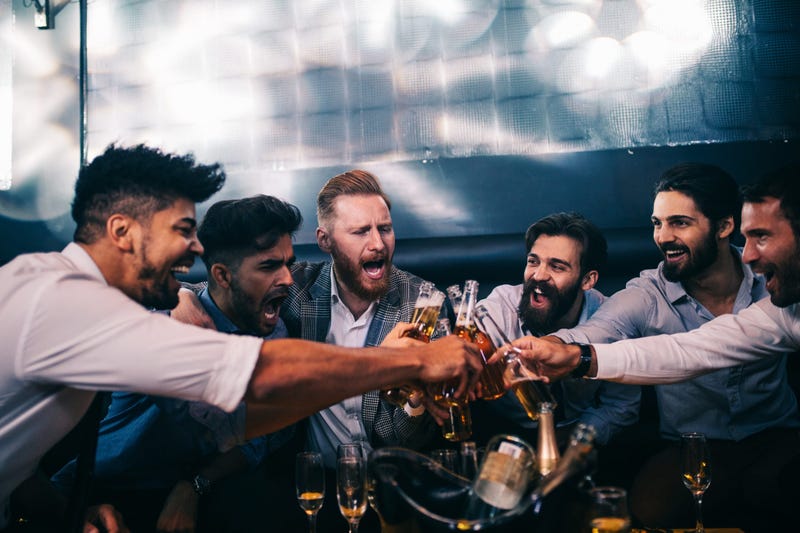 Dudes cheering beers at a bachelor party