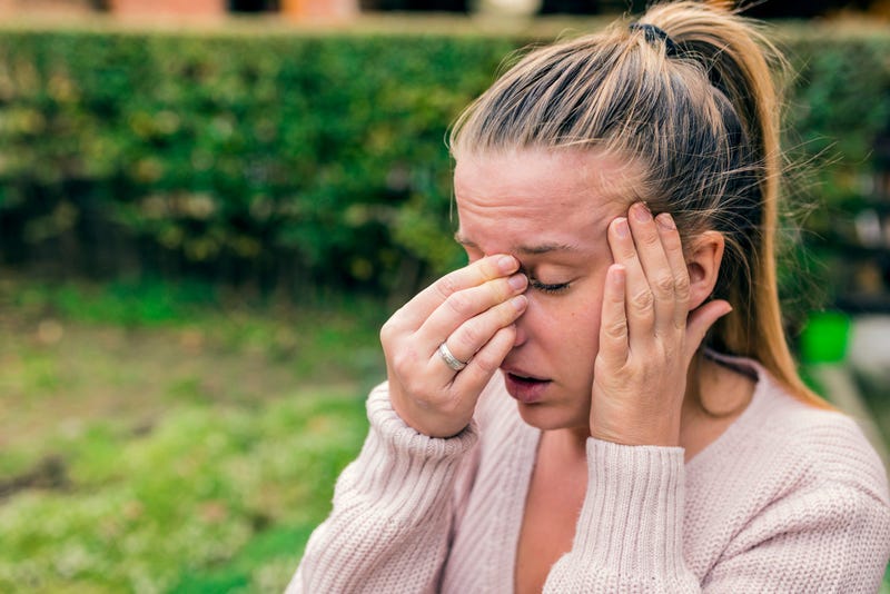 Girl holding nose