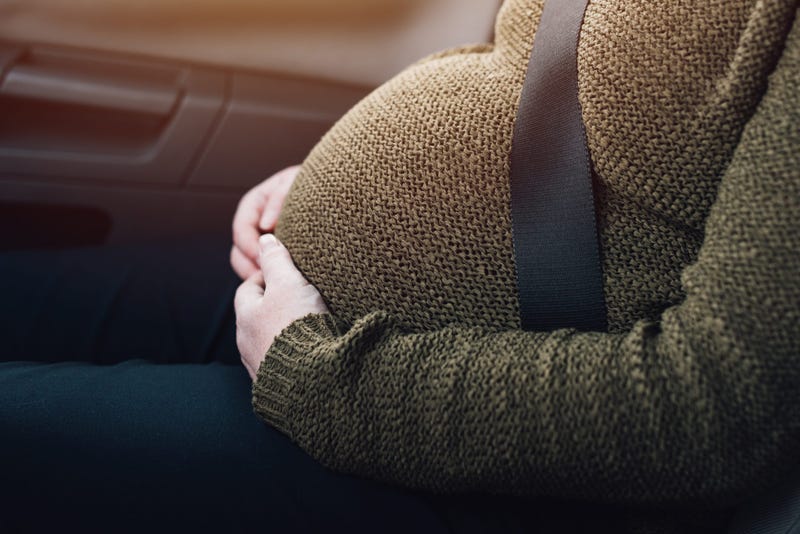 Pregnant woman seat belted in car