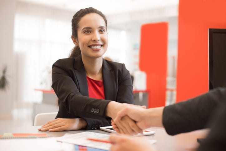 Latin Businesswoman Shaking Hands with Partner