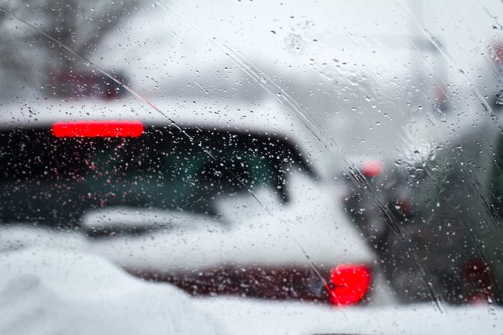 Some rain and snow on a car. 