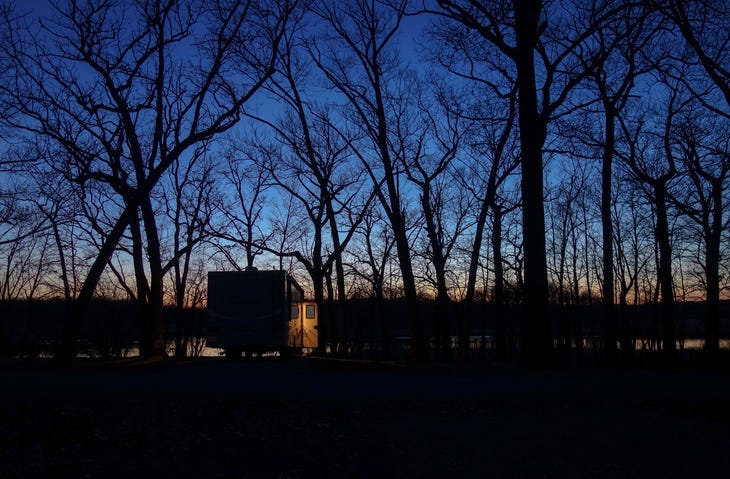 RV in woods.