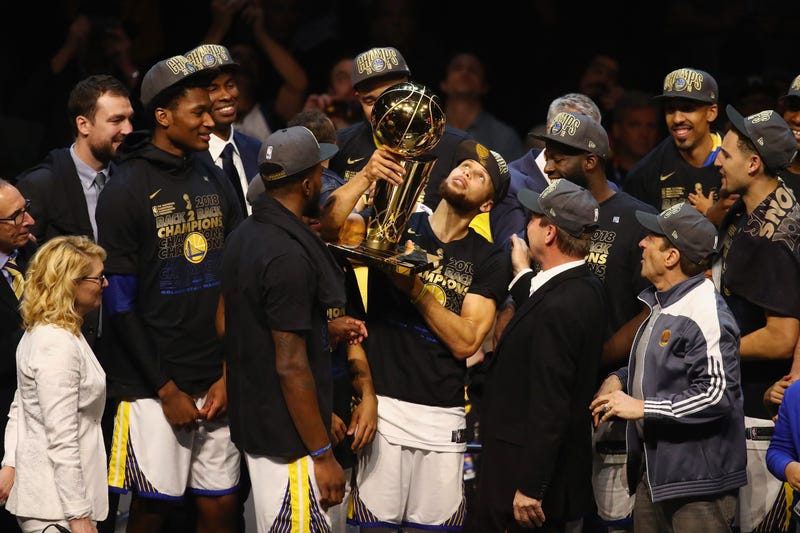 : Stephen Curry #30 of the Golden State Warriors celebrates with the Larry O'Brien Trophy after defeating the Cleveland Cavaliers during Game Four of the 2018 NBA Finals at Quicken Loans Arena on June 8, 2018 in Cleveland, Ohio. 