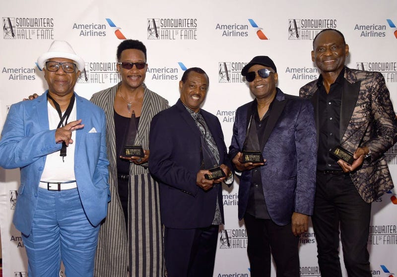 Dennis Thomas, James "JT" Taylor, Robert "Kool" Bell, Ronald Bell, and George Brown of Kool & The Gang pose with their awards.