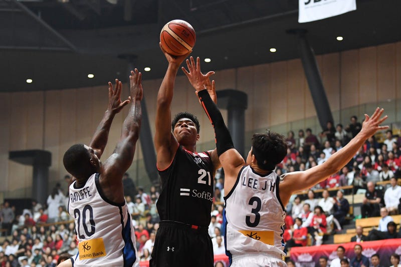 Rui Hachimura shoots over two defenders during the Japan-South Korea - Basketball International Game in Tokyo on June 15, 2018