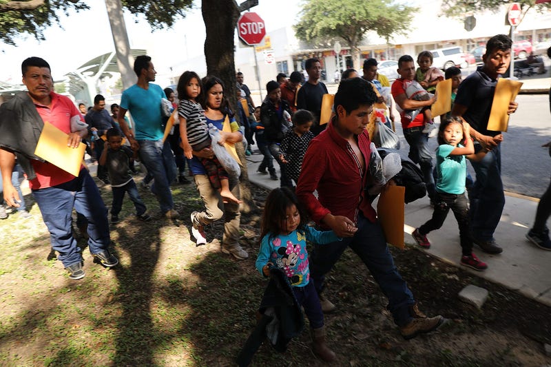 Dozens of women, men and their children, many fleeing poverty and violence in Honduras, Guatamala and El Salvador, arrive at a bus station following release from Customs and Border Protection on June 23, 2018 in McAllen, Texas. 