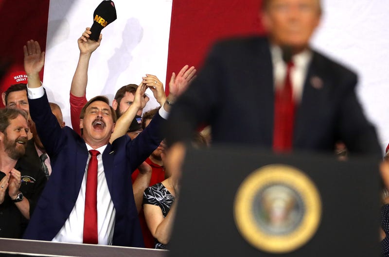 Michael J. Lindell (L) CEO of My Pillow, cheers as U.S. president Donald Trump speaks to supporters during a campaign rally at Scheels Arena on June 27, 2018 in Fargo, North Dakota.