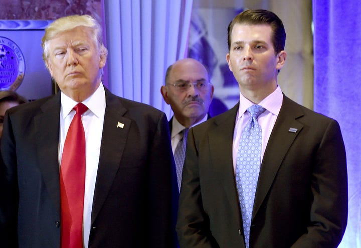 File photo: US President-elect Donald Trump along with his son Donald, Jr., arrive for a press conference at Trump Tower in New York, as Allen Weisselberg (C), chief financial officer of The Trump, looks on January 11, 2017