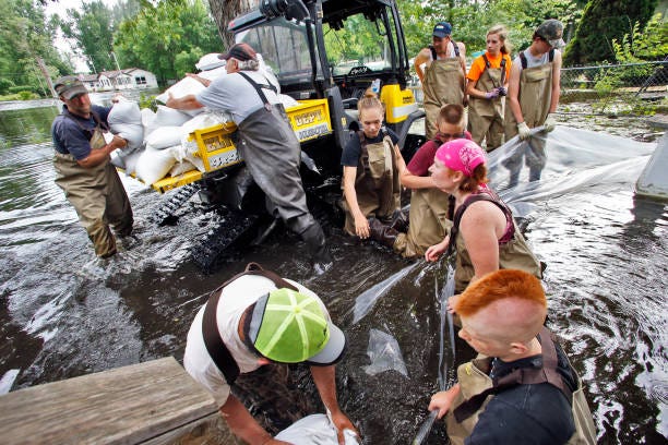 Always ready with a helping hand, Waterville residents sandbag homes along the shoreline of Lake Tetonka where homes are being flooded as a result of recent heavy rains in 2014.
