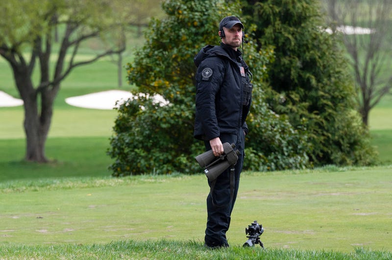 A US Secret Service sniper watches the course as US President Joe Biden plays a round of golf at Wilmington Country Club in Wilmington, Delaware on April 17, 2021. - President Joe Biden played golf for the first time in his presidency Saturday, hitting the fairways in his home city of Wilmington