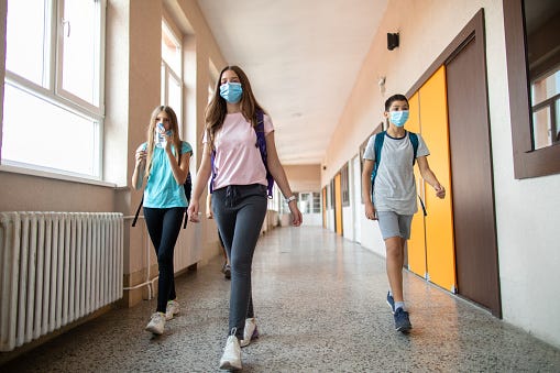 School students walking down a hallway between classes