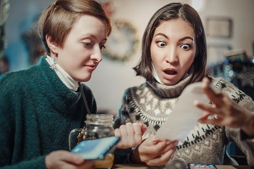 Friends Looking At Dinner Check